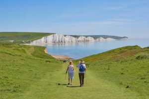 To people walking toward coastal scenery